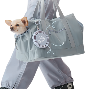 Portable Collapsible Dog Bowl for Travel - Lightweight & Foldable Design for Outdoor Adventures Small dog peeking out of a grey travel bag with a folded grey collapsible silicone dog bowl clipped on the side.